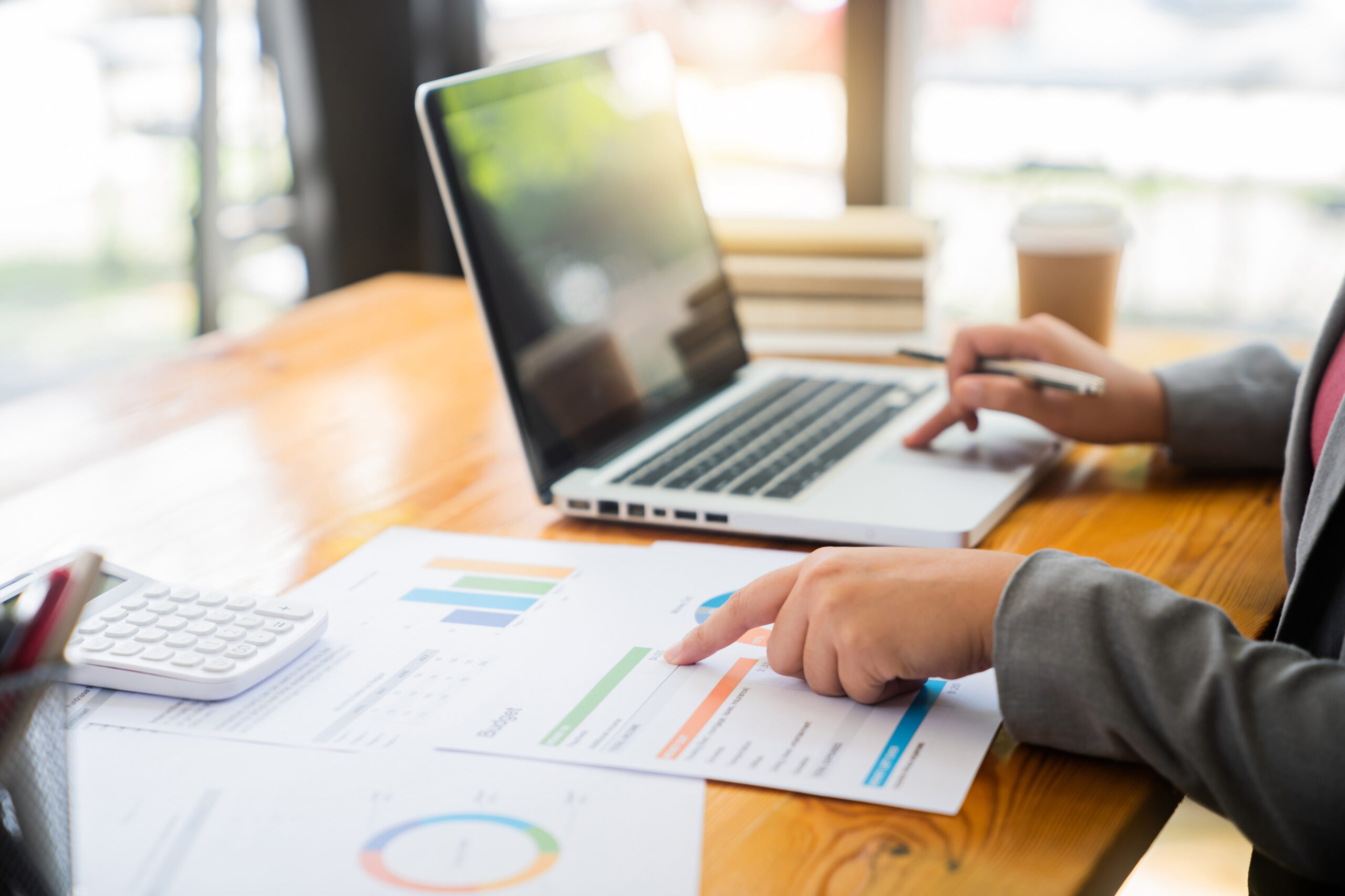 Accountant or banker making calculations Bookkeeper Clerk, Bank Advisor And Auditor. Accounting concept Mah Financial Services